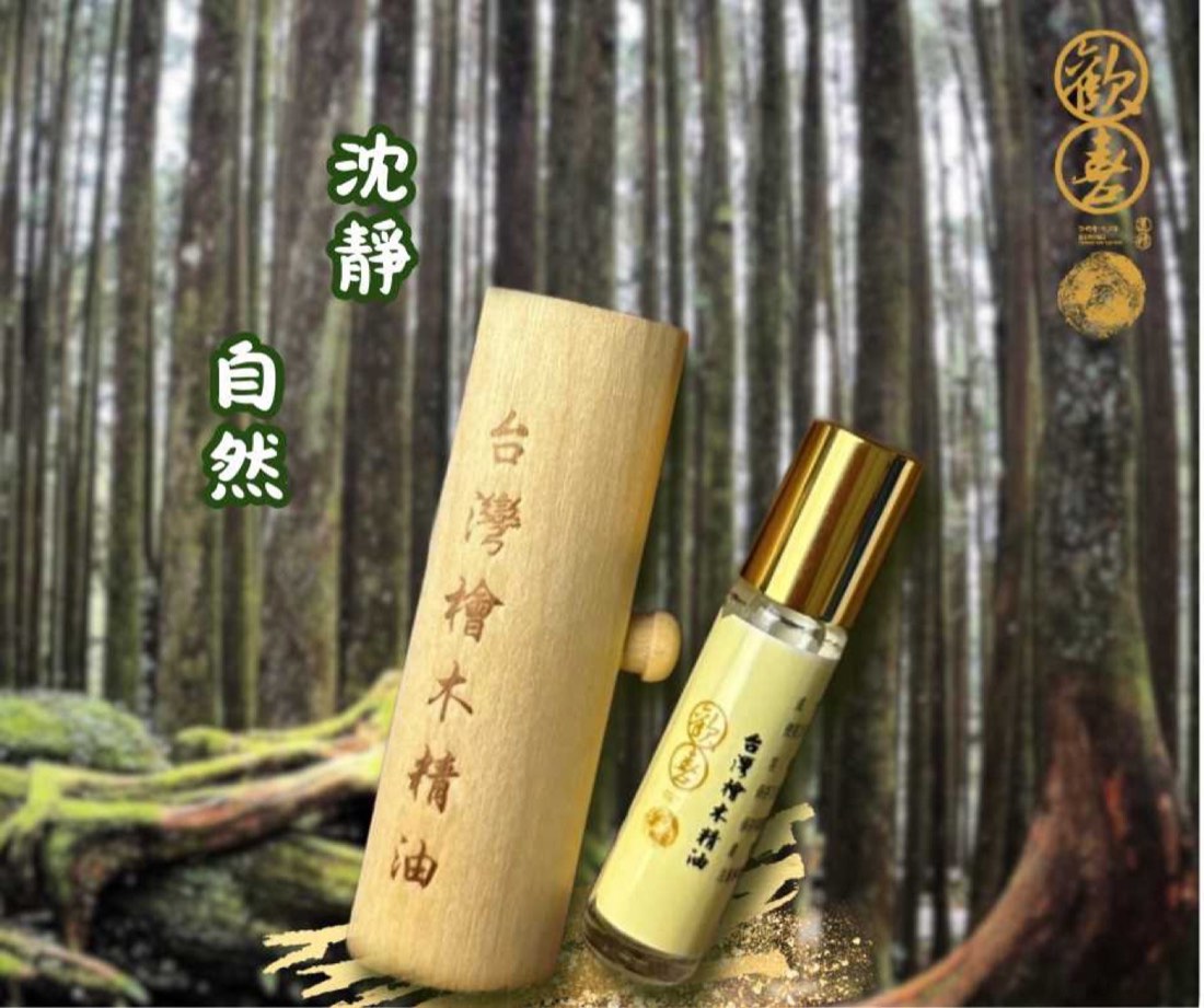 歡喜園台灣檜木精油滾珠瓶與原木收納筒,置於台灣檜木林間